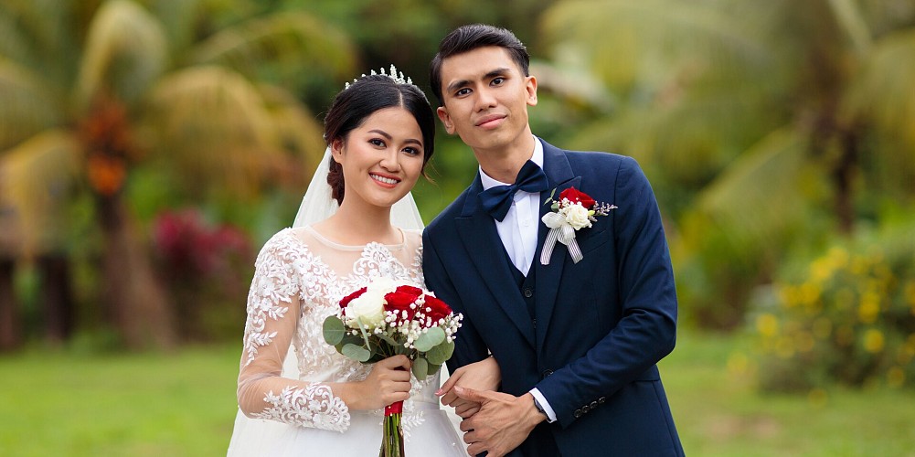 A couple getting married in a tropical garden